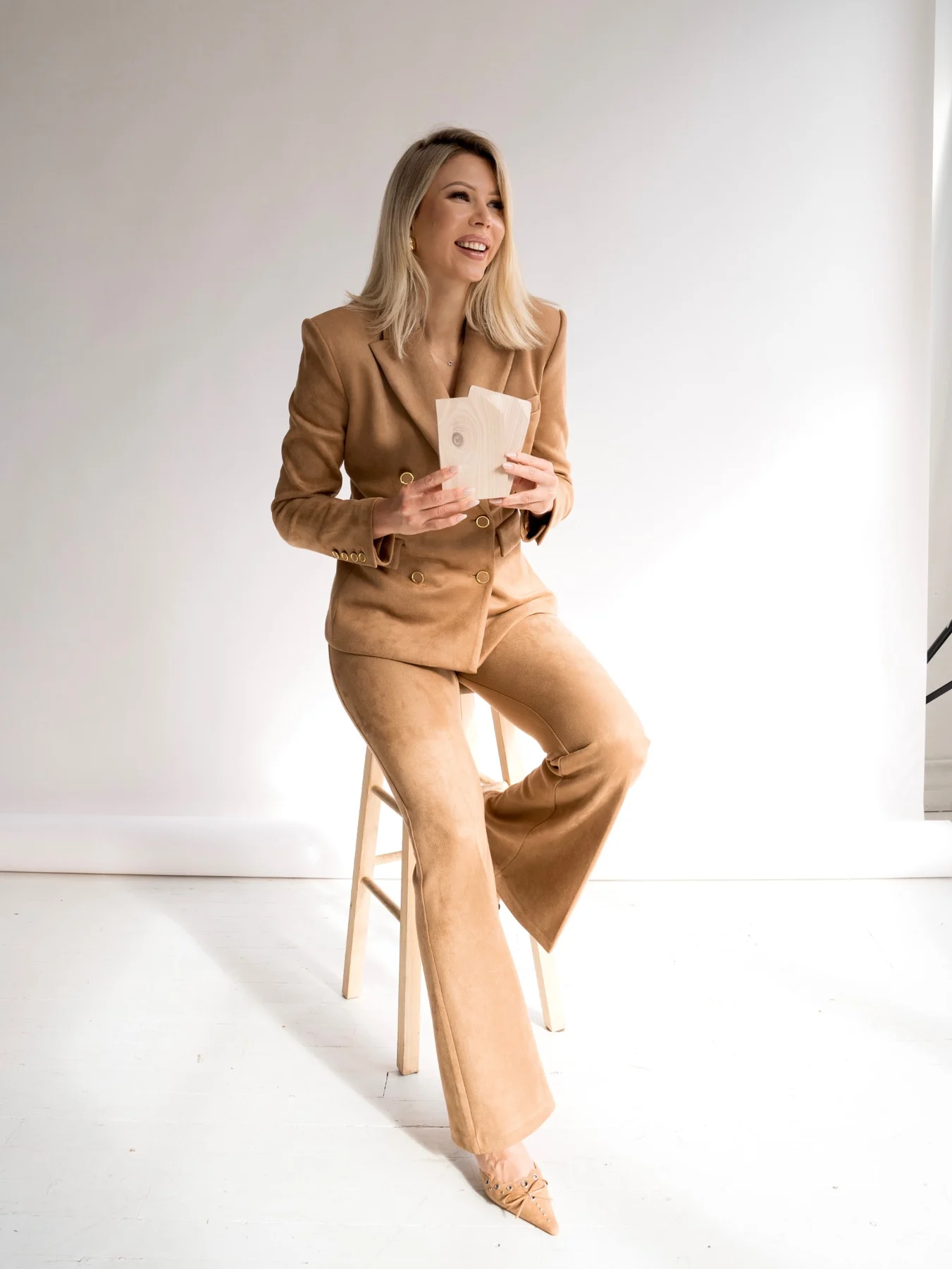 Floorika company CEO holding wood flooring samples