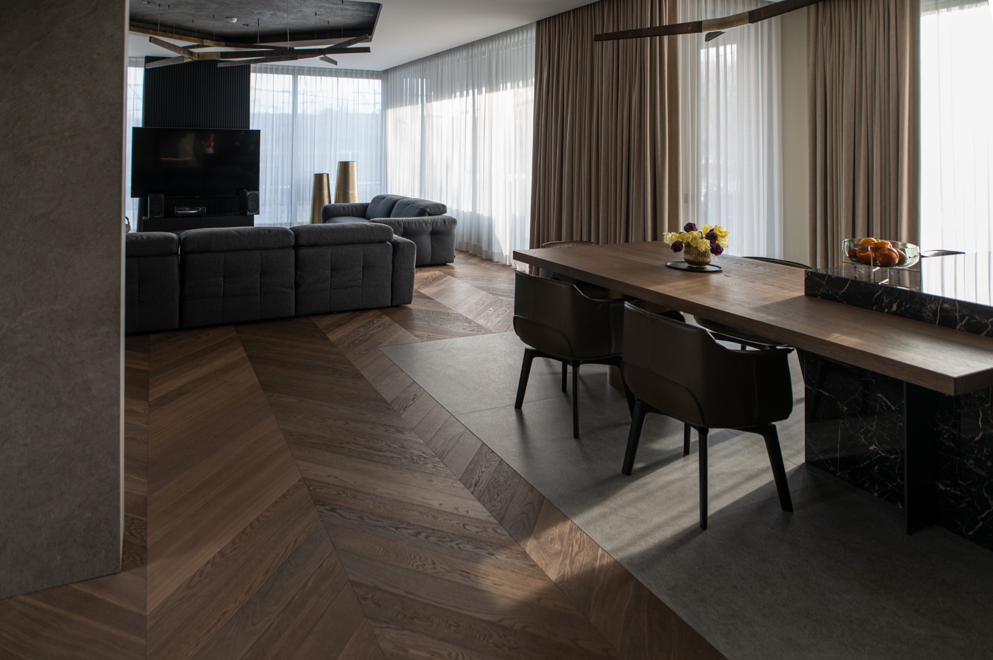 Dark contemporary room with wide plank hardwood flooring